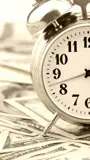 a clock on a pile of money