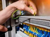 hand working on wires